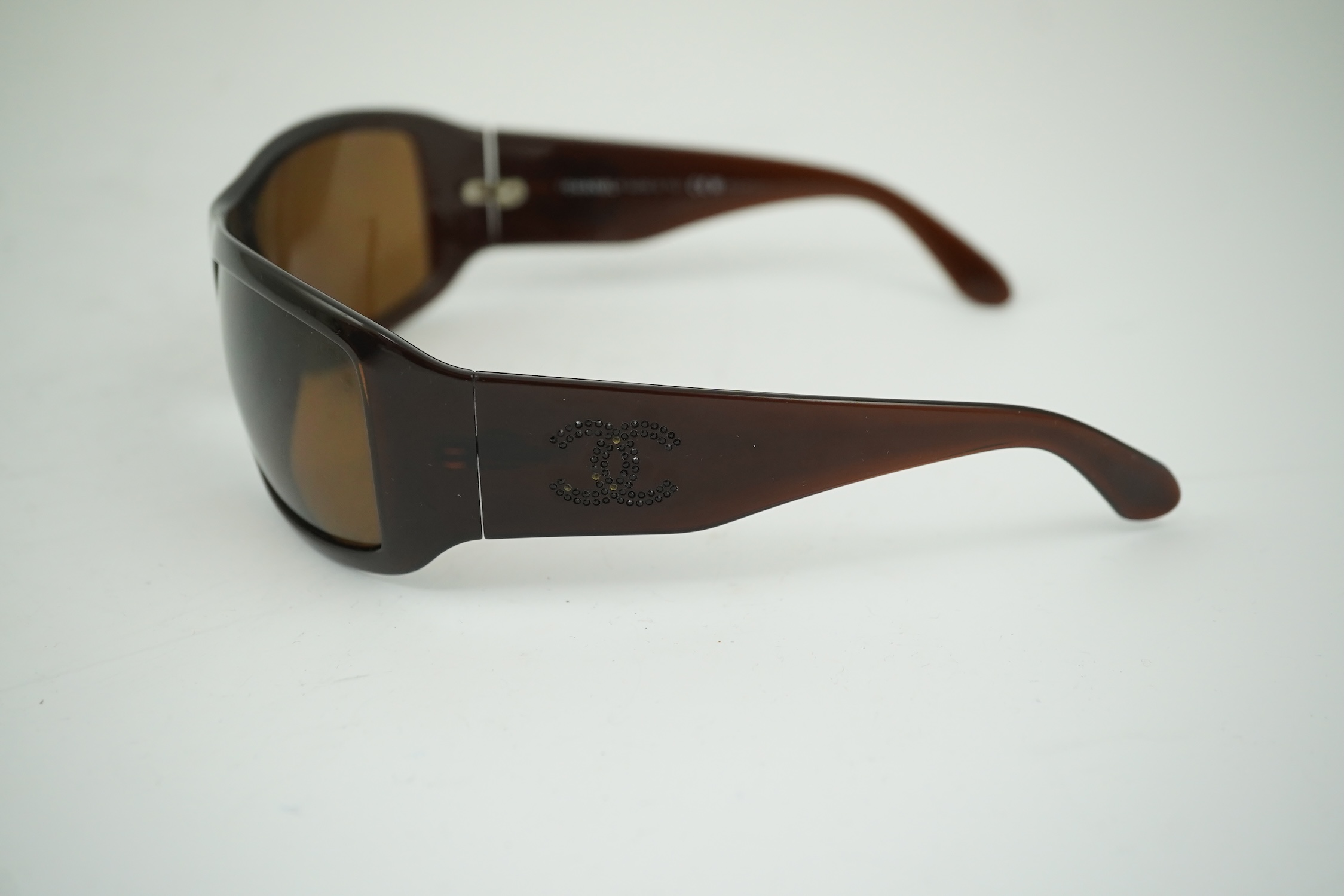 A pair of lady's brown Chanel sunglasses with hard case